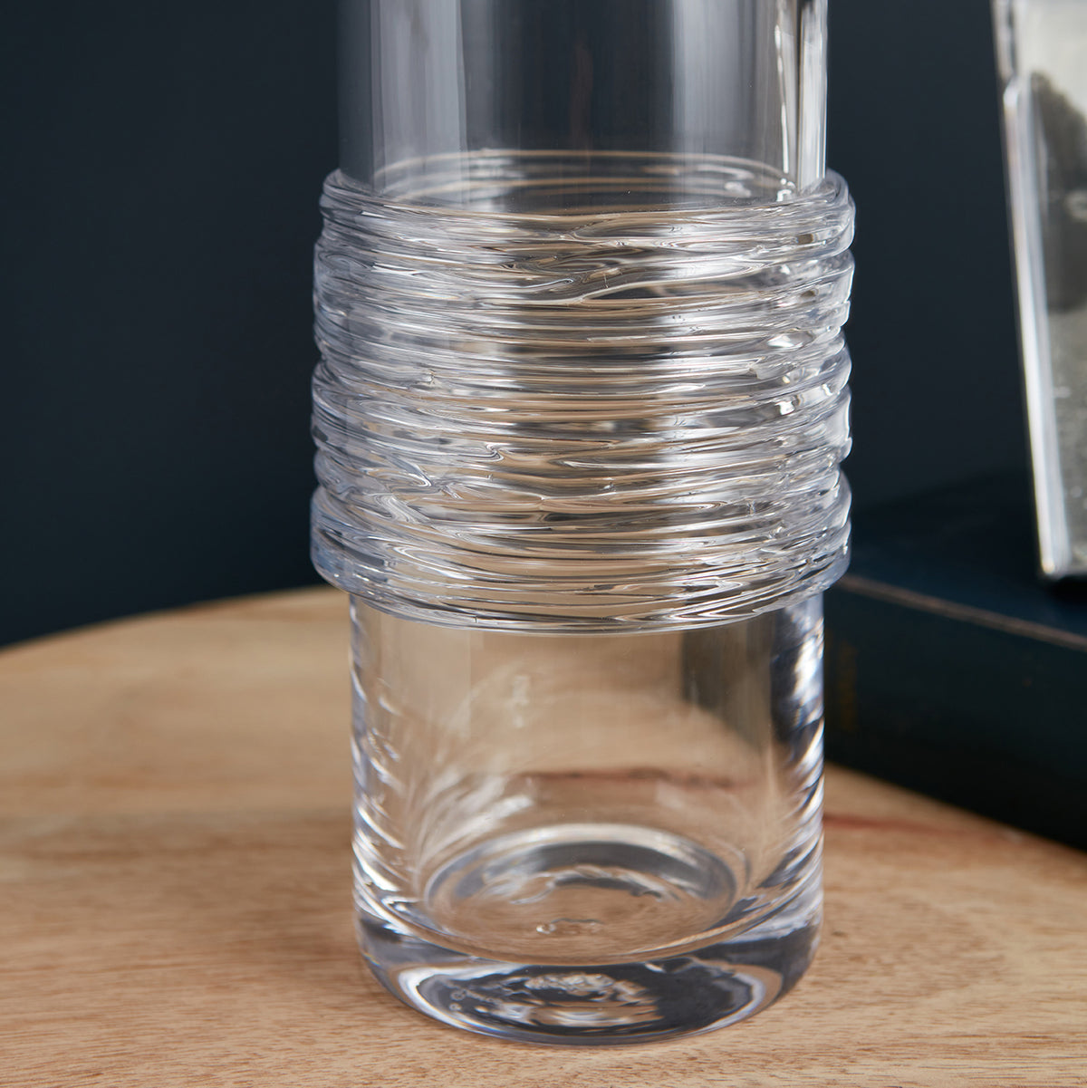 Clear glass cylinder with textured horizontal band detail around middle section.