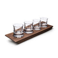 Four clear glass whiskey tumblers arranged on a rectangular walnut wood base.