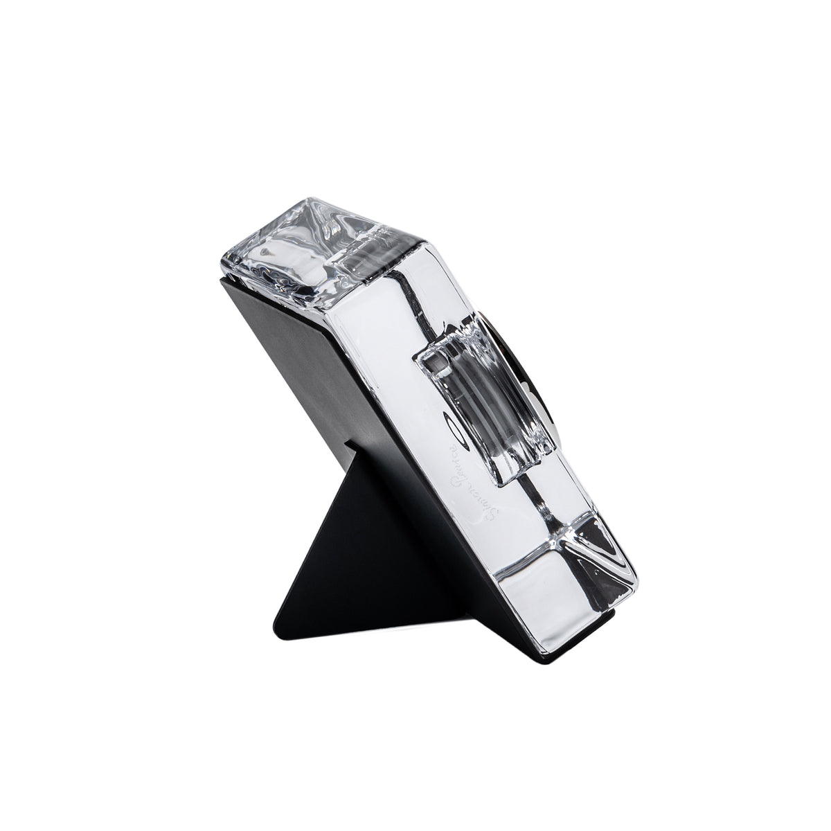 Square table clock with white and black color block design and triangular stand base.