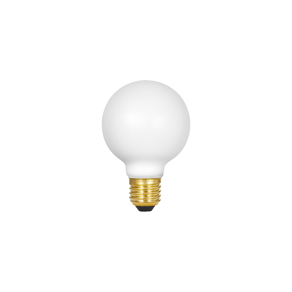 Spherical matte white LED bulb with brass threaded base and black contact point.