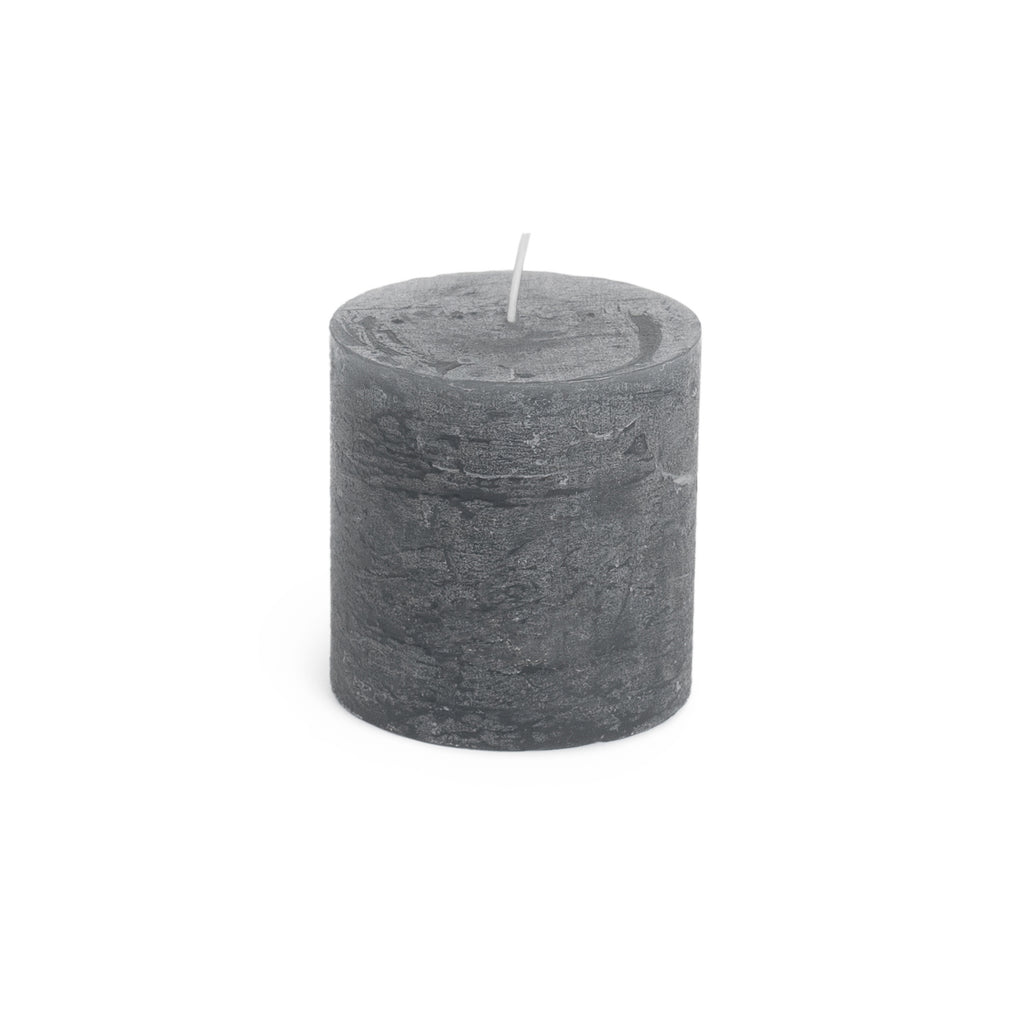 Grey cylindrical pillar candle with white wick, textured finish surface.