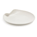 White ceramic platter with organic curved shape and small handle indent on one side.