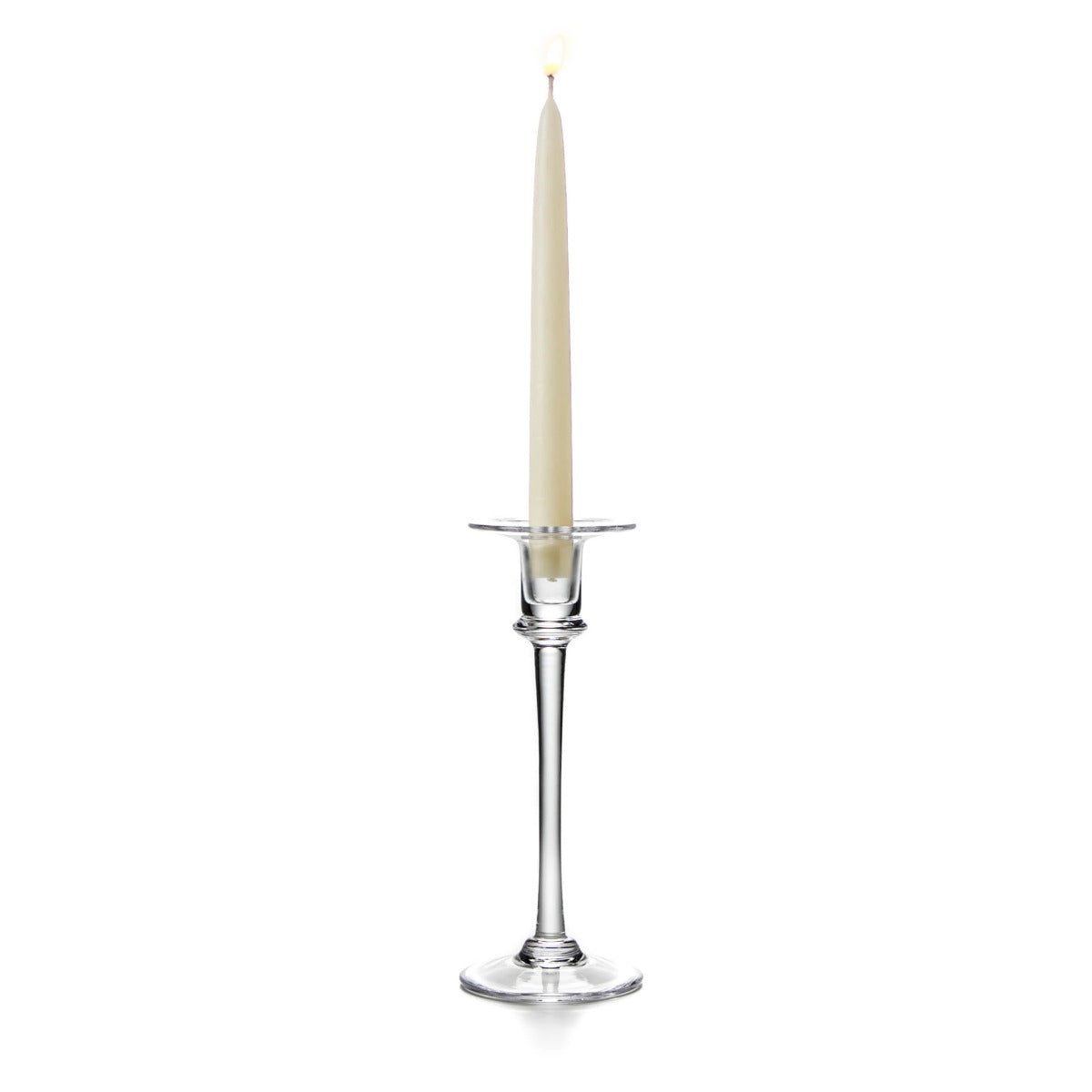 Tall clear glass candlestick with a cream taper candle and metal bobeche, tapered stem, and circular base.
