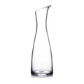 Clear glass carafe with curved sides, angled pouring spout, and rounded rim.