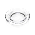 Clear glass round coaster with textured rim and shallow center well.
