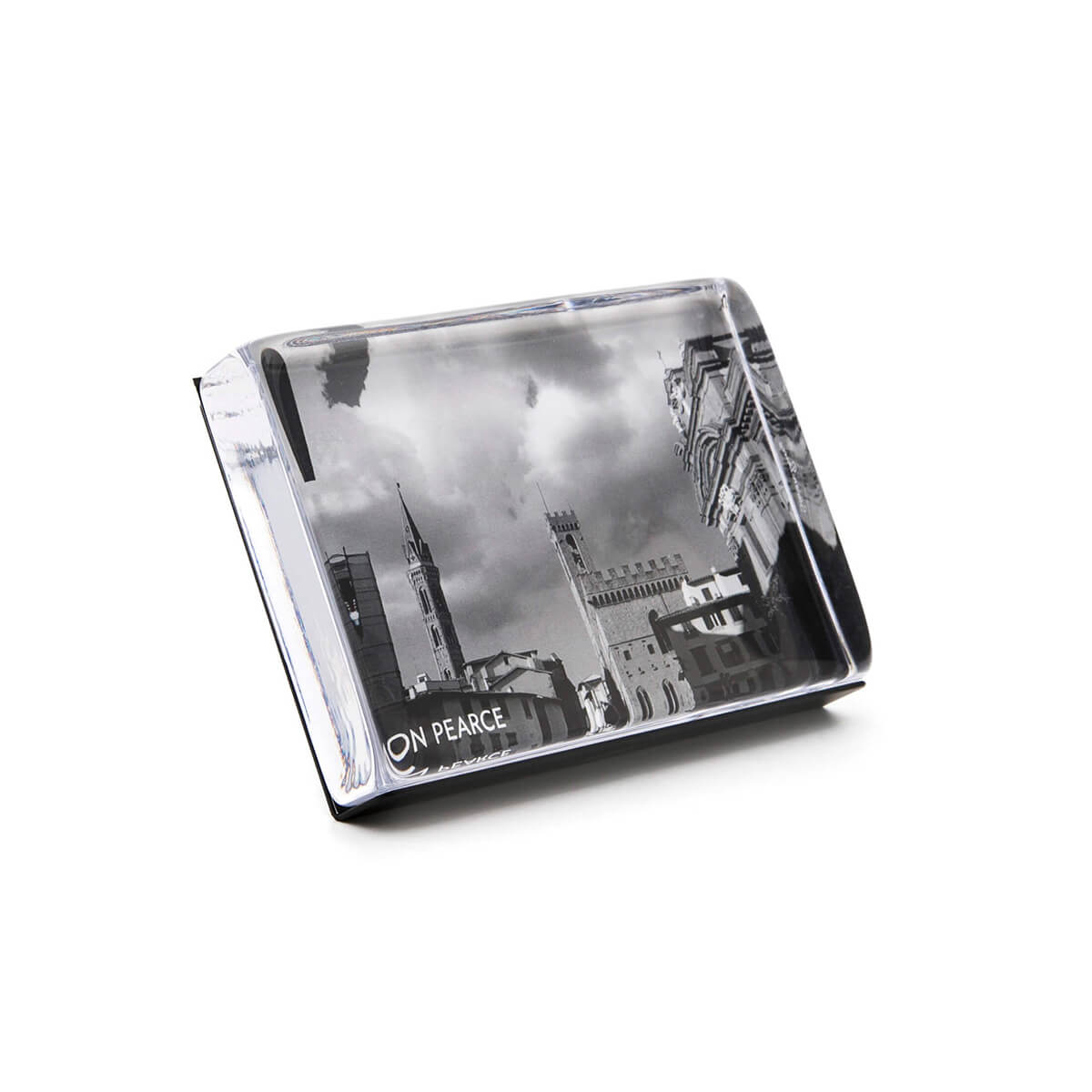 Black and white photo block with cityscape image featuring tall buildings and cloudy sky.