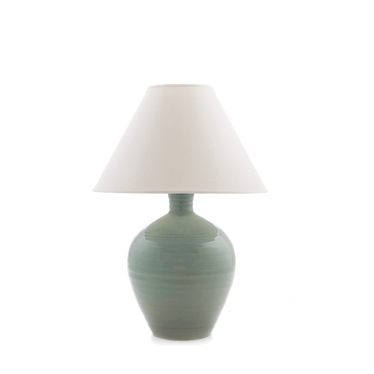 Ceramic table lamp with sage green bulbous base and cream linen tapered shade.