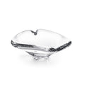 Clear glass dish with heart-shaped top and black branch-like handles on sides.