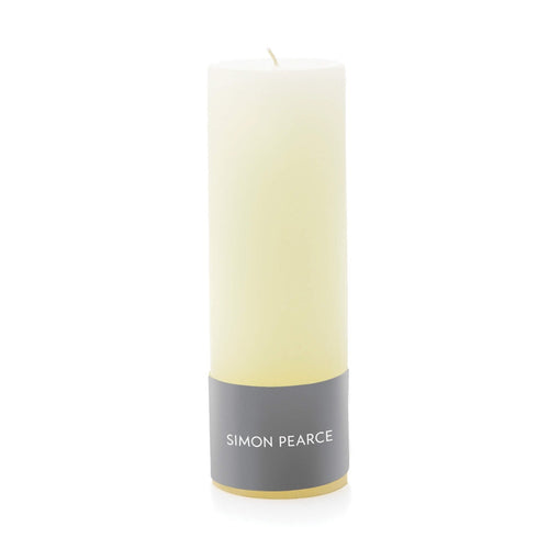 Ivory pillar candle with gray band label and cream-colored wick.