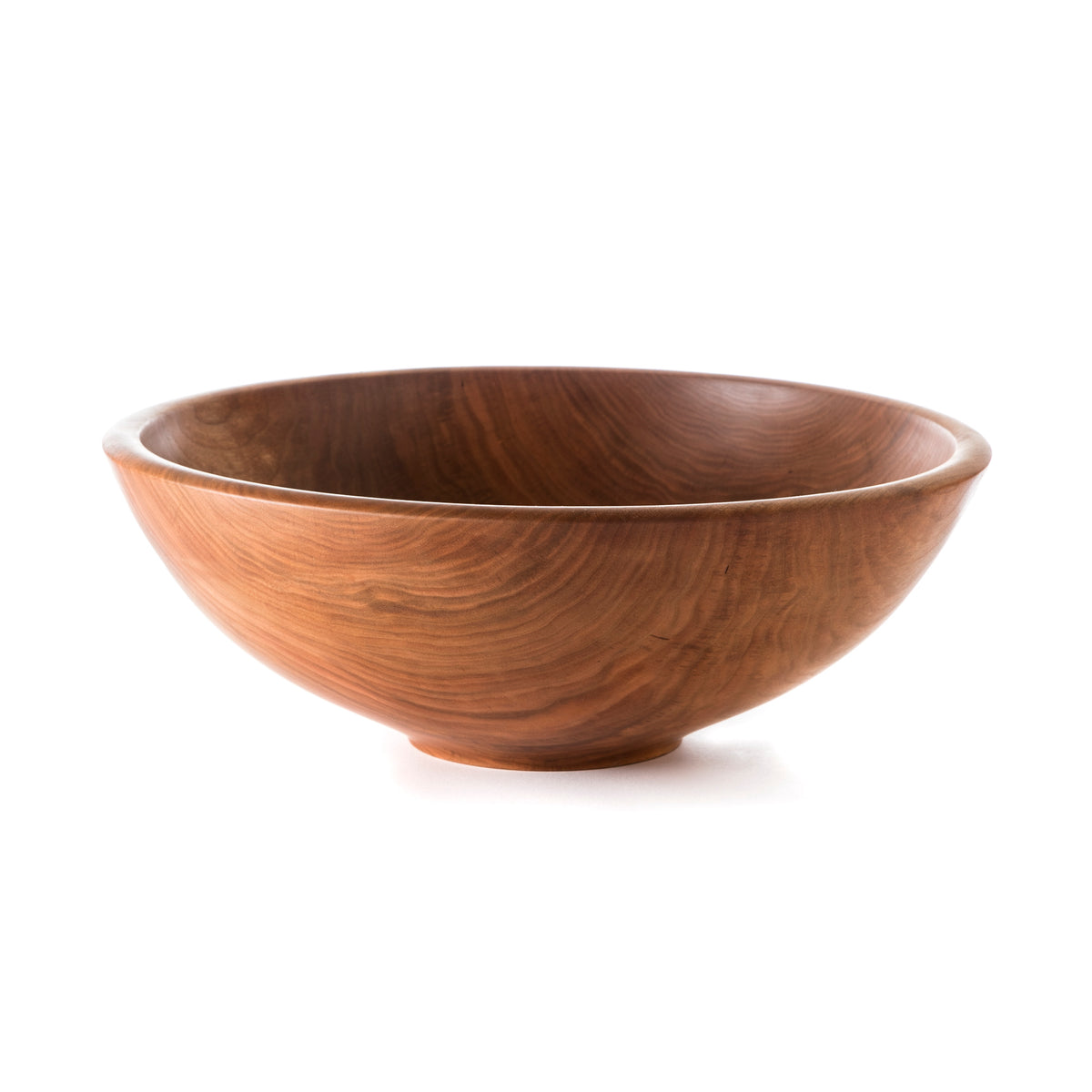 Cherry wood bowl with smooth curved sides and visible grain patterns throughout.