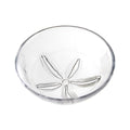 White ceramic bowl with sand dollar pattern embossed on interior bottom.