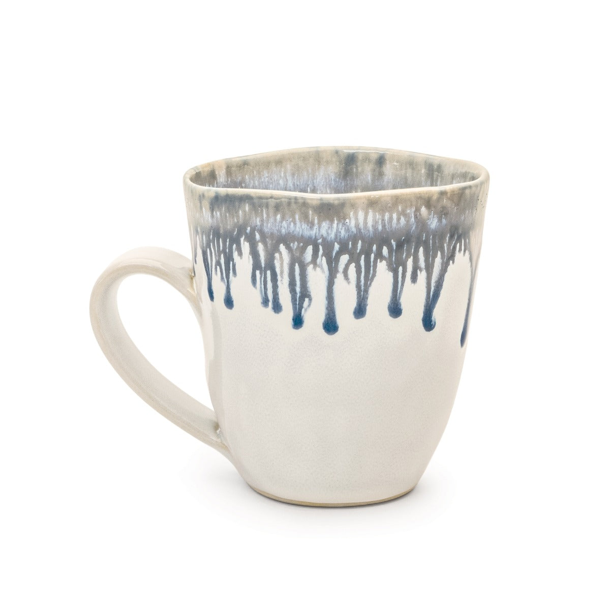 Cream ceramic mug with blue drip glaze pattern on upper rim and interior.