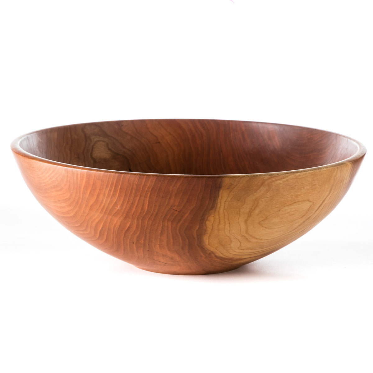 Cherry wood bowl with curved sides and smooth finish, displaying natural grain patterns and warm reddish-brown tones.