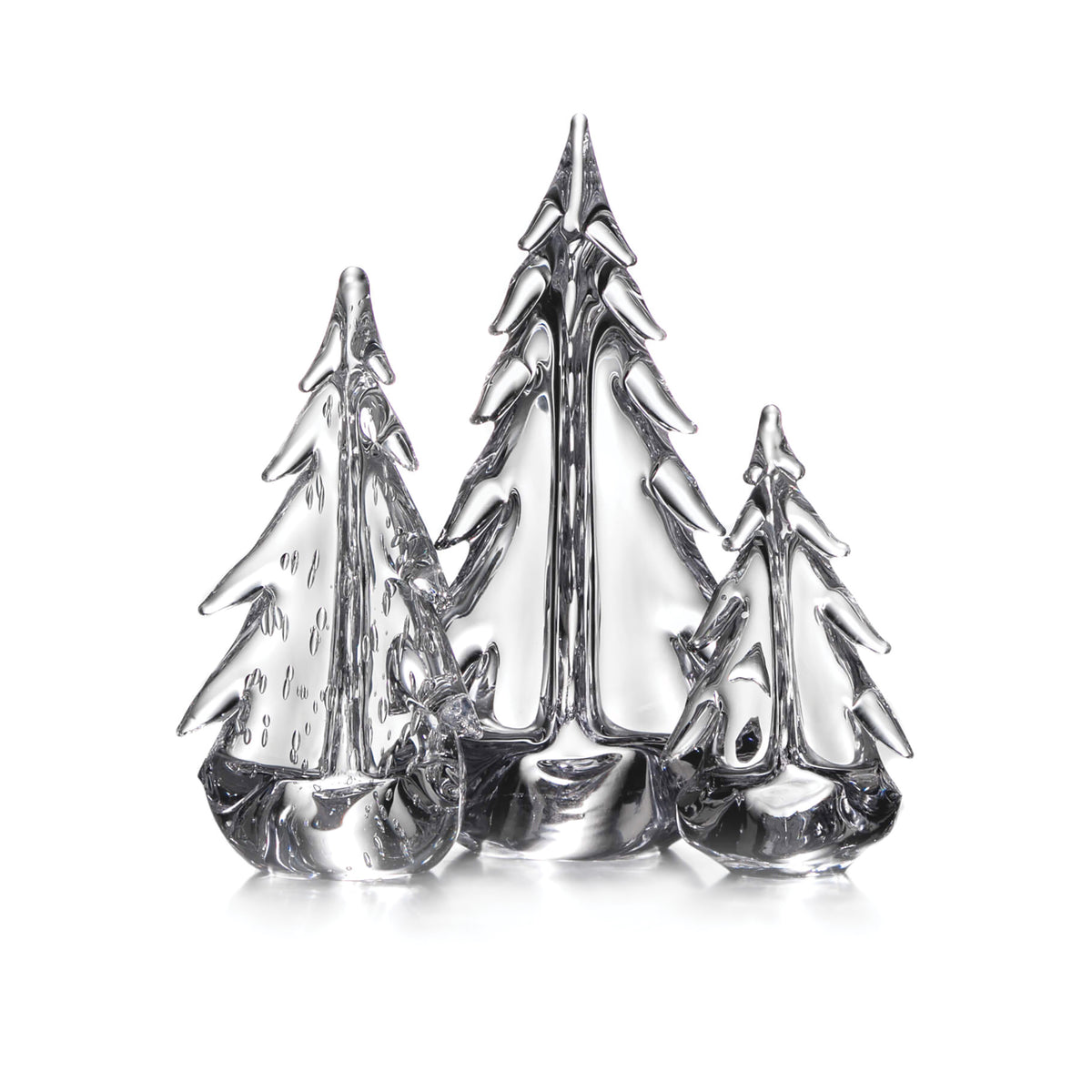 Three silver-colored glass evergreen trees in varying heights with detailed branch etching and reflective surfaces.
