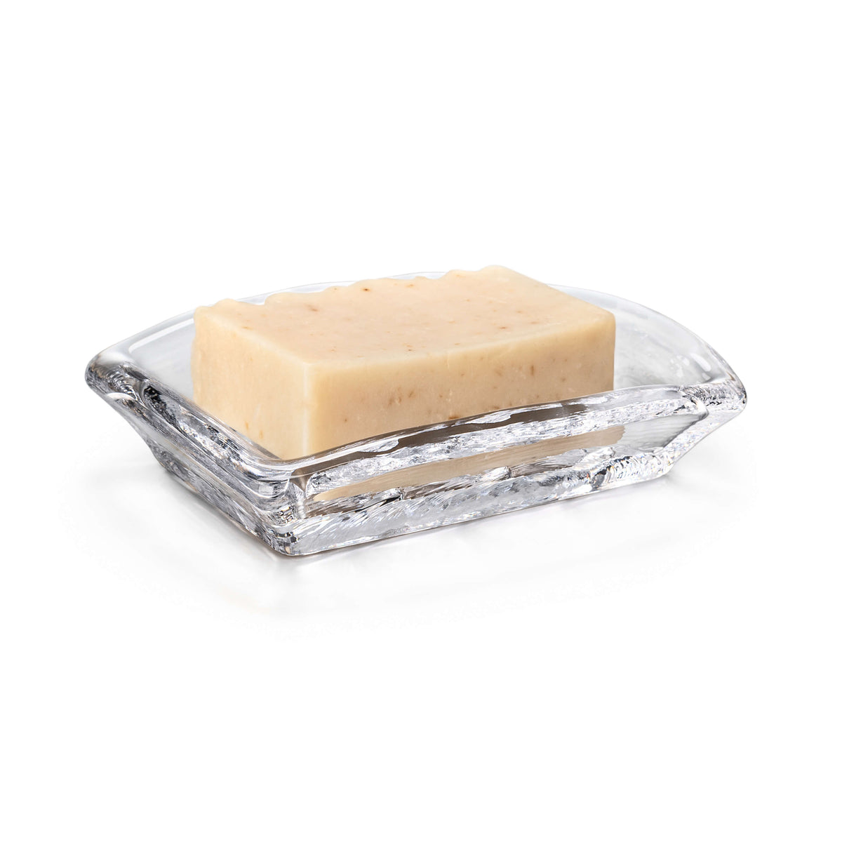 Clear glass soap dish with textured surface holding a cream-colored bar of soap.