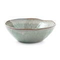 Moss green ceramic pasta bowl with organic wavy rim and mottled glaze finish.