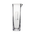 Clear glass carafe with tapered cylindrical body and pouring spout on upper right side.