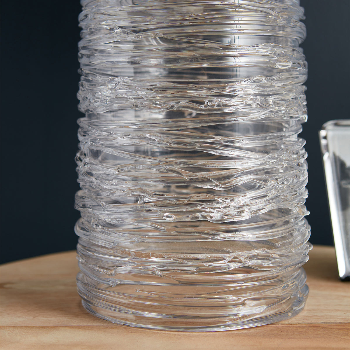 Clear glass cylindrical lamp base with horizontal wave texture pattern throughout.