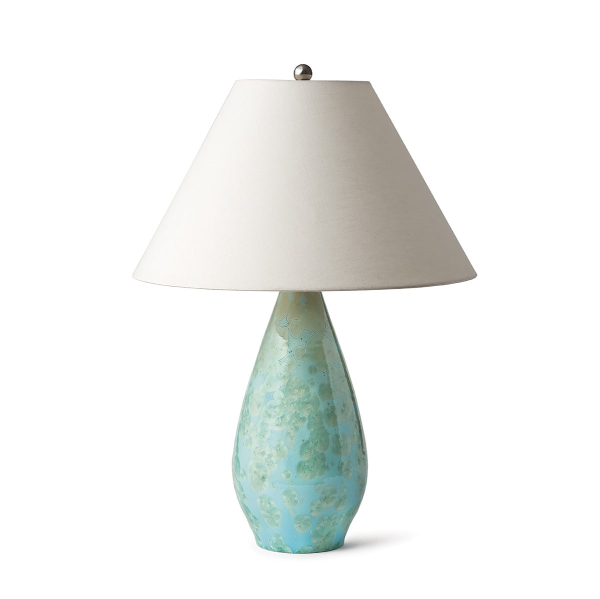 Blue-green textured ceramic base lamp with cream linen shade and brushed metal finial.