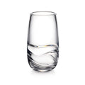 Clear glass tumbler with curved wavy design detail on lower half and tapered sides.