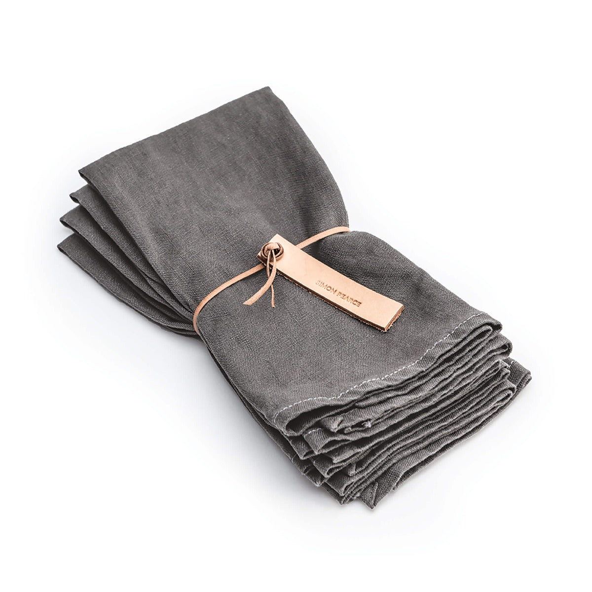 Four grey linen napkins with hemmed edges, bundled together with a tan leather tie.