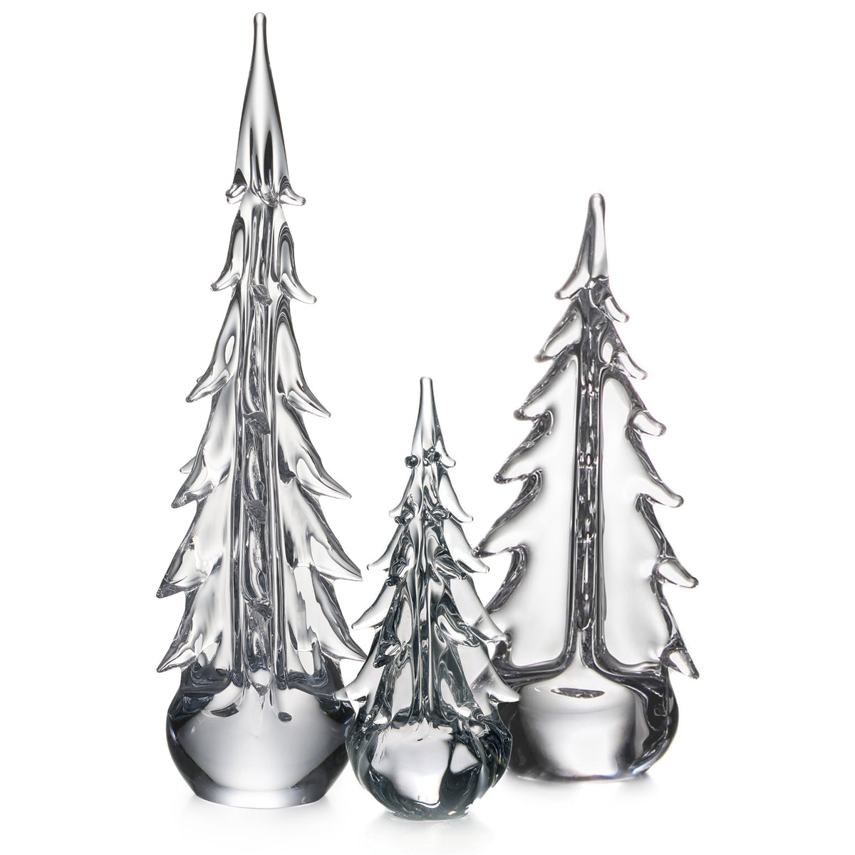 Three clear glass evergreen trees in graduating sizes with pointed tops and layered branch details on solid bases.