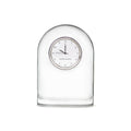 Clear glass dome-shaped clock with circular face displaying numbers and "Simon Pearce" branding.