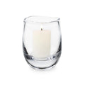 Clear glass hurricane vase containing a cream-colored pillar candle with single wick.