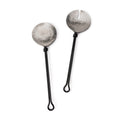 Two serving spoons with hammered silver bowl heads and black handles with loop ends.