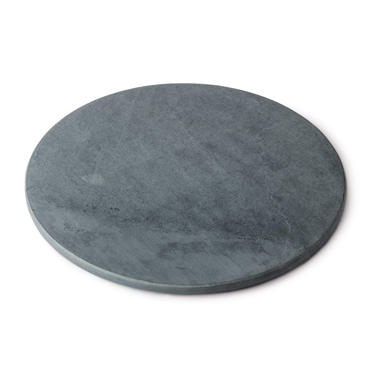 Round grey soapstone board with flat surface and slightly beveled edge.