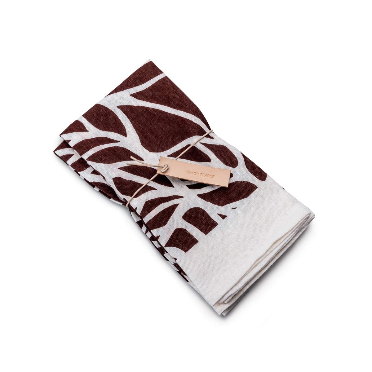 Two folded napkins with garnet and white leaf block print pattern, tied with a tan fabric band.