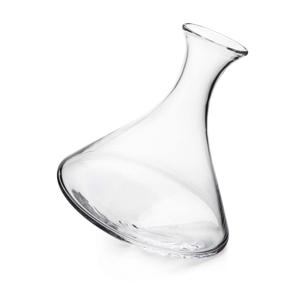 Clear glass wine decanter with curved body and angled spout, tilted at an angle.
