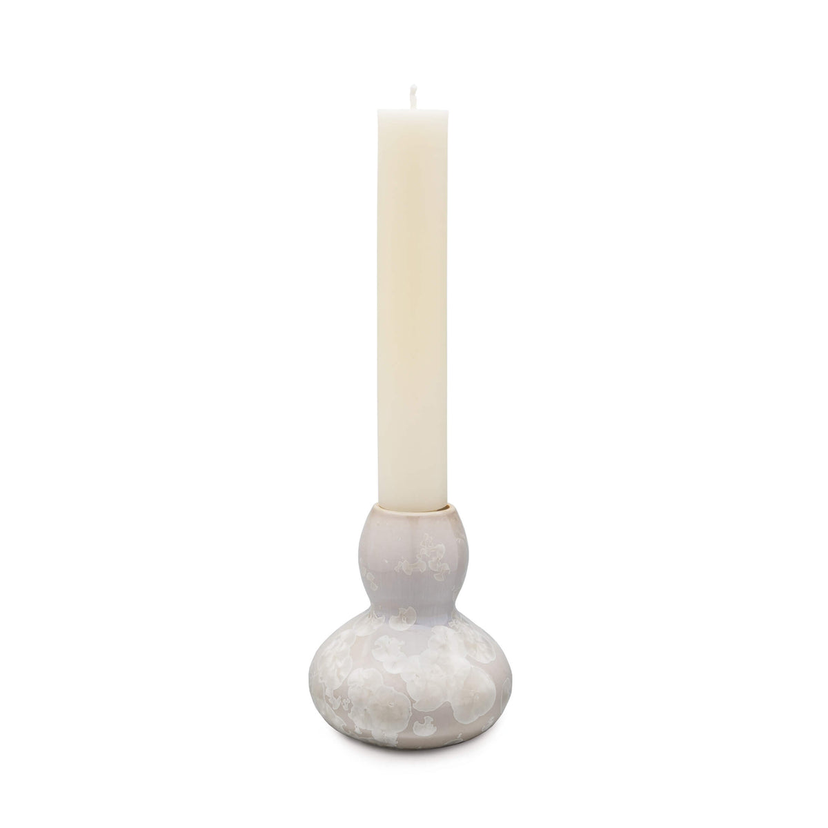 White crystalline candlestick holder with bulbous base and cylindrical socket holding a cream taper candle.