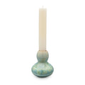 Jade-colored crystalline candlestick with bulbous base holding a cream pillar candle.
