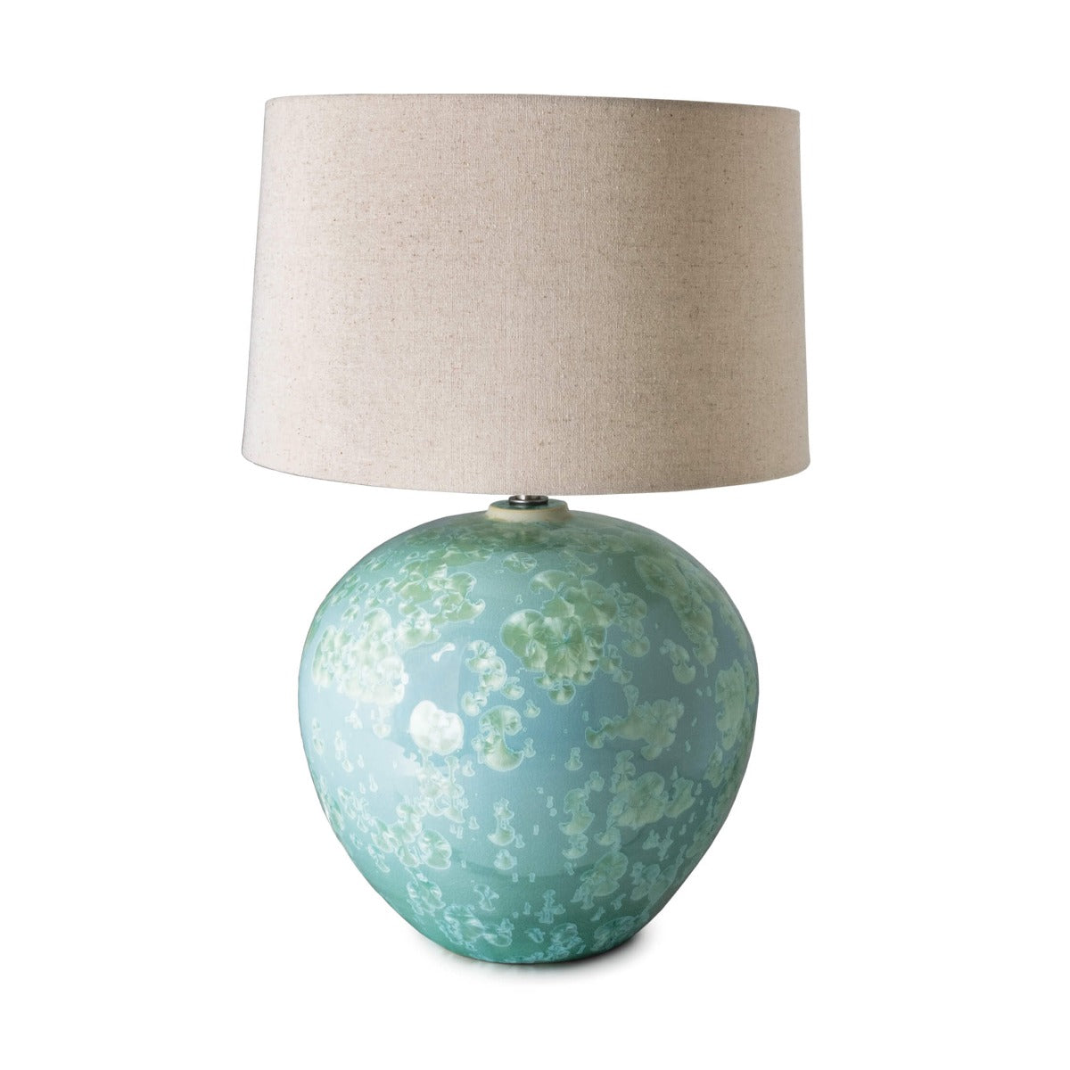 Jade-green spherical lamp base with textured glaze topped by a cream linen drum shade.