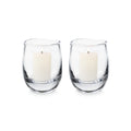 Two clear glass hurricane candleholders with cream-colored pillar candles inside.