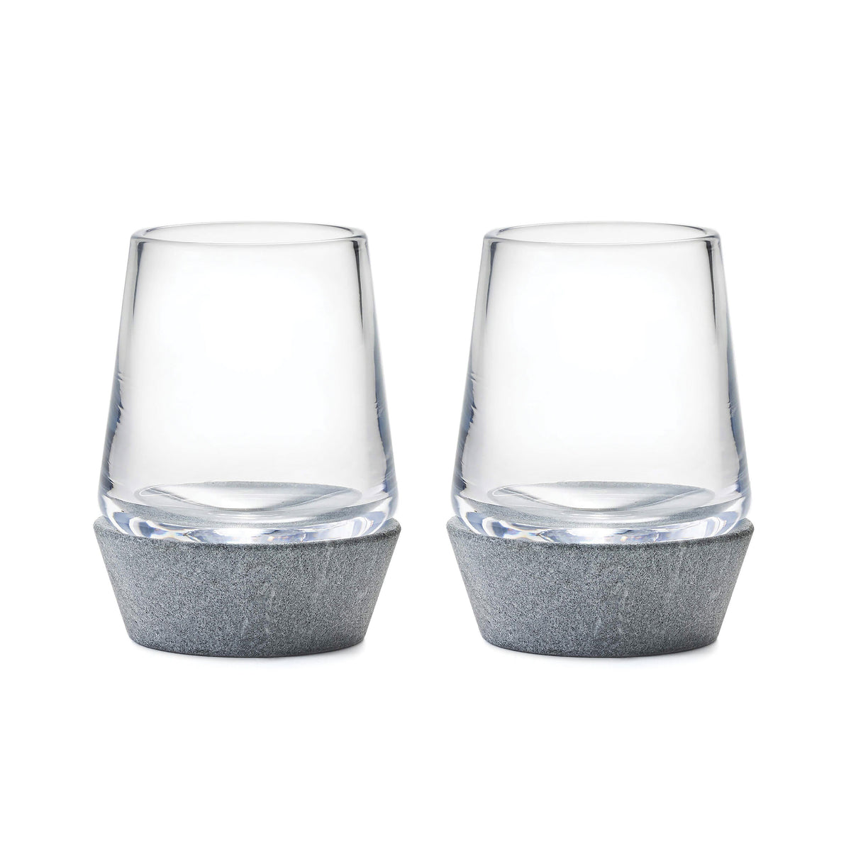 Two clear whiskey glasses with gray felt bases.
