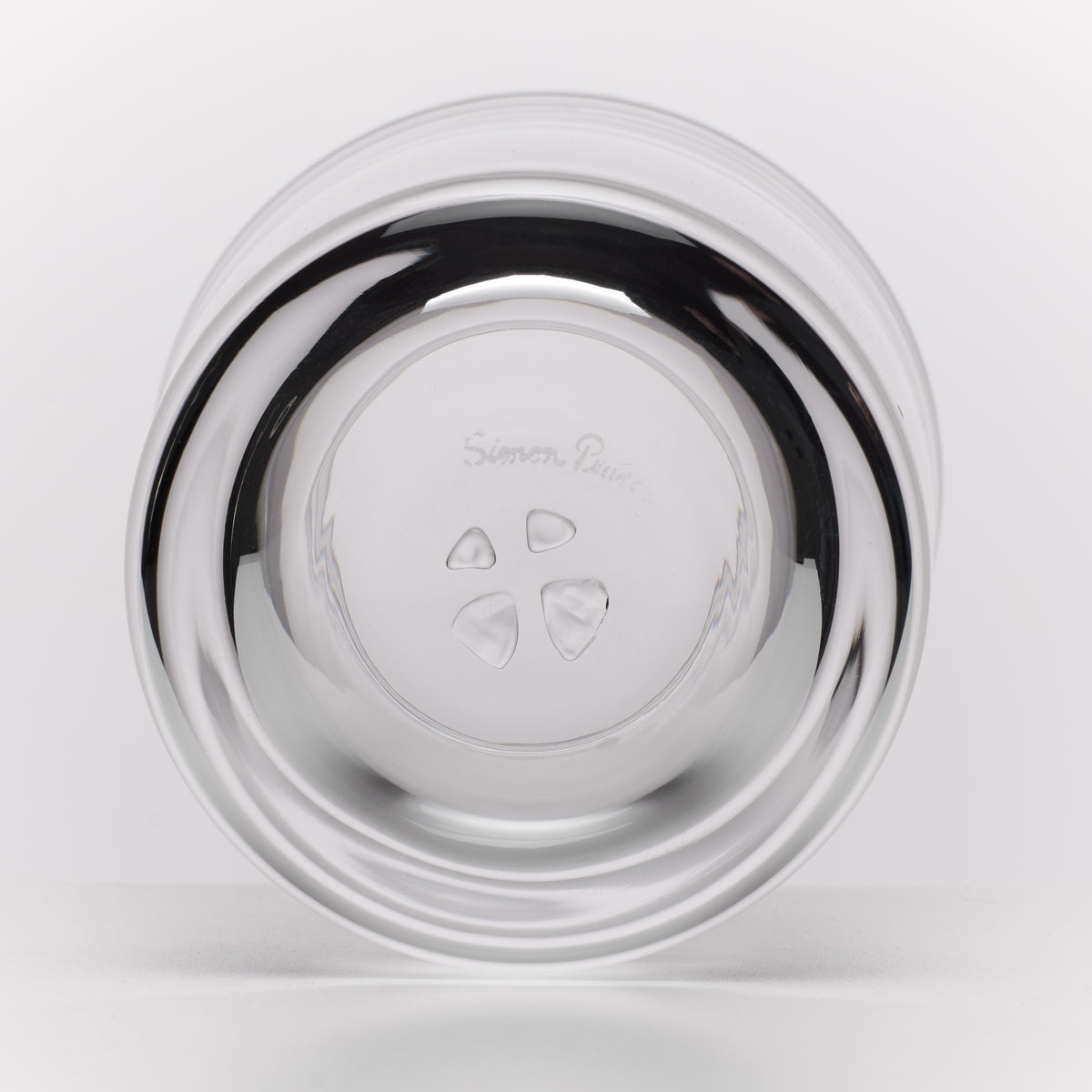 A round glass photographed from the bottom on a clean white background.