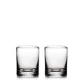 Two clear glass whiskey glasses with thick bases, empty and positioned side by side.
