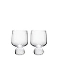 Two clear glass cups with rounded bowls and bulbous bases on white background.