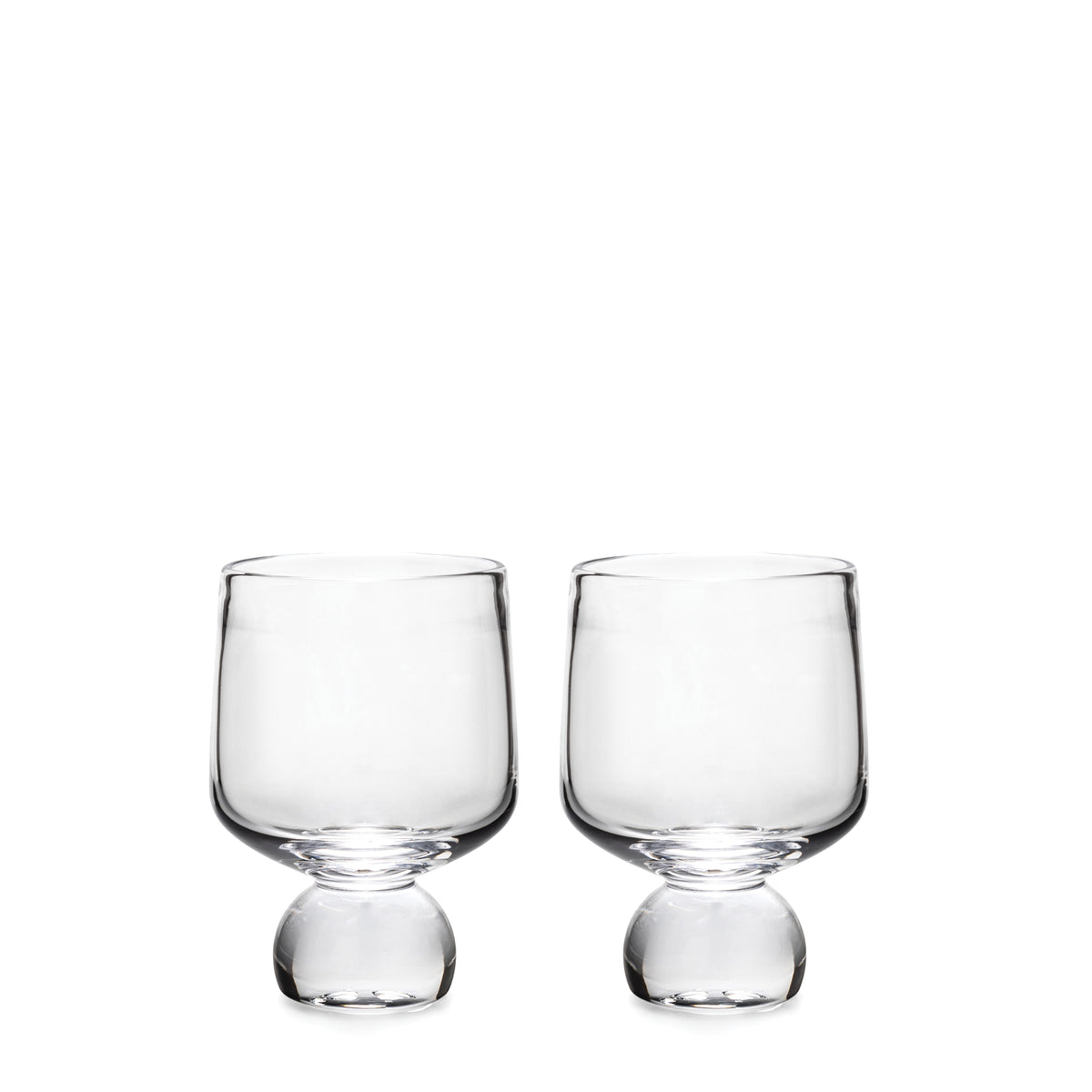 Two clear glass cups with rounded bowls and bulbous bases on white background.