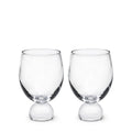 Two clear glass tumblers with rounded bases and wide bowls, displayed side by side.