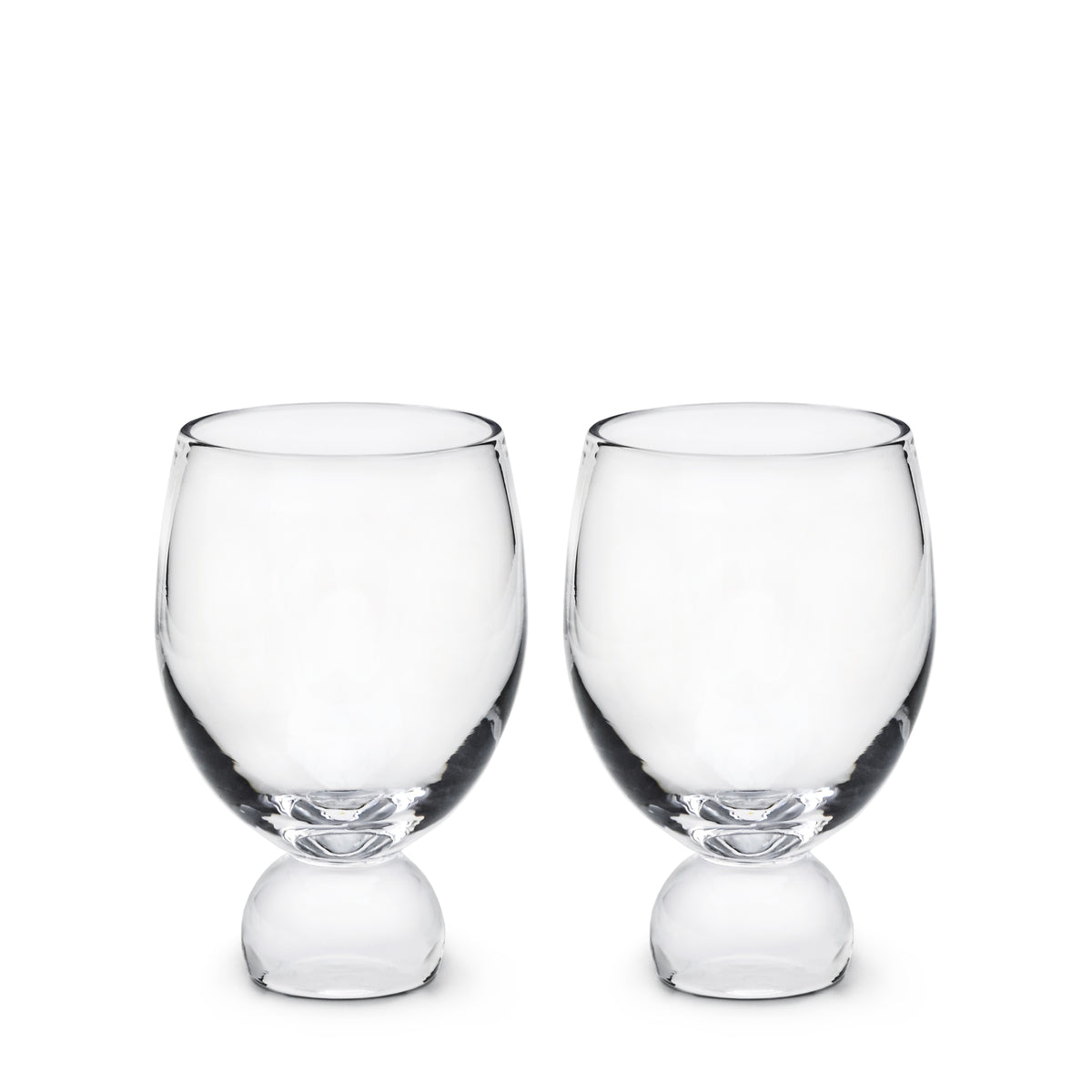 Two clear glass tumblers with rounded bases and wide bowls, displayed side by side.