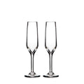 Two clear glass champagne flutes with tapered bowls and thin stems on white background.