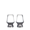 Two clear glass tasting glasses with tapered bowls and weighted bases.