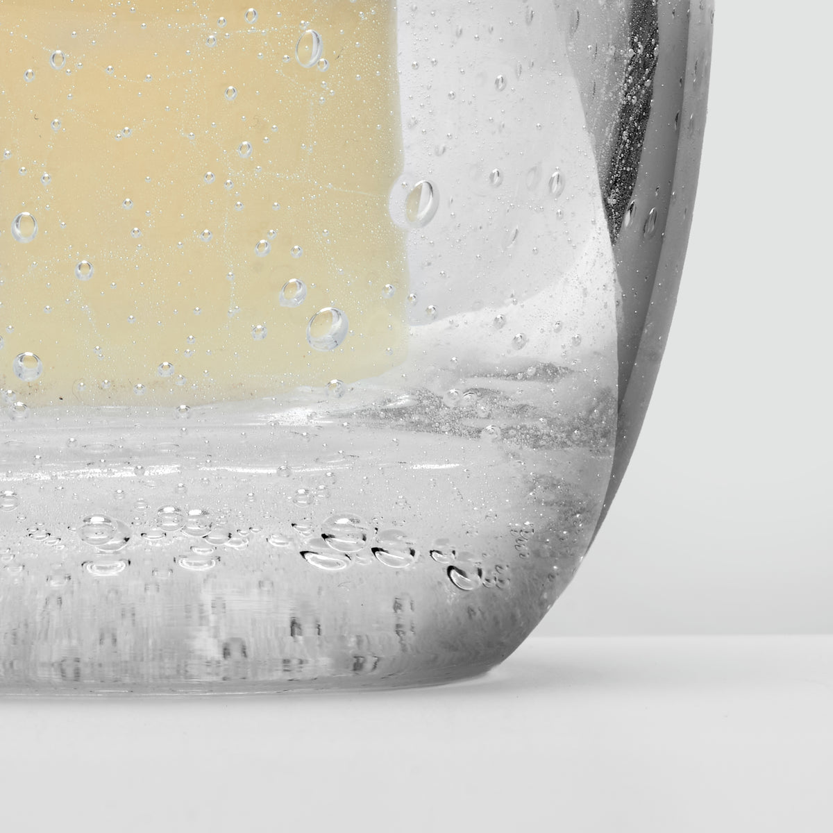 Clear glass basin with water droplets and condensation, showing interior curved surface.