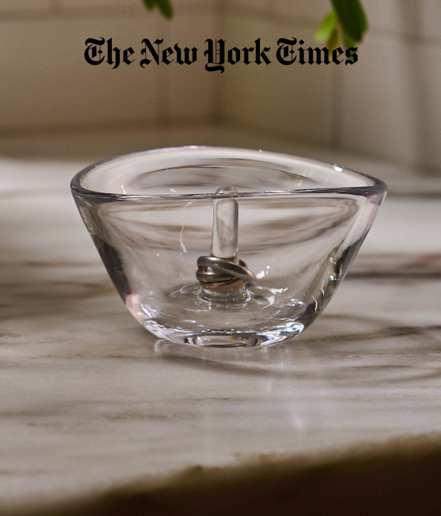 Simon Pearce handblown glass ring holder on a marble surface, featured in The New York Times