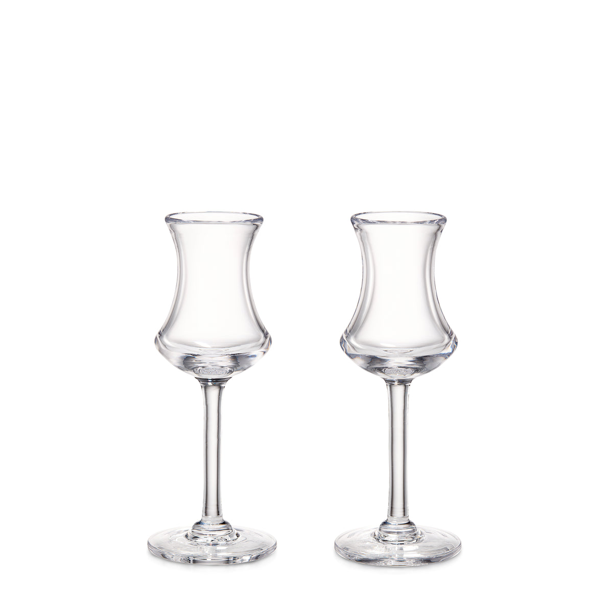 Two clear glass aperitif glasses with curved bowls and thin stems on circular bases.