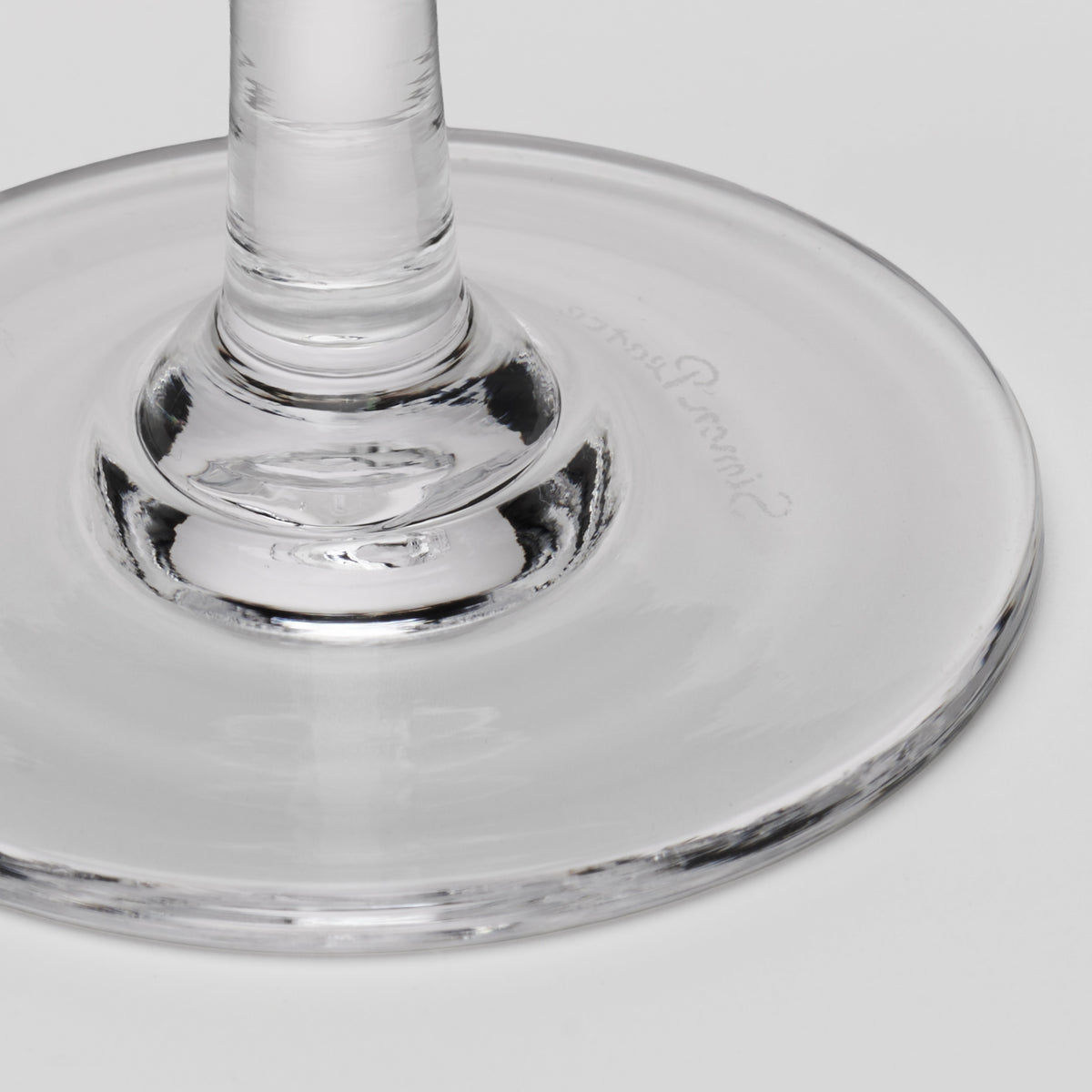 Clear glass coupe glass with wide bowl and pedestal stem base.
