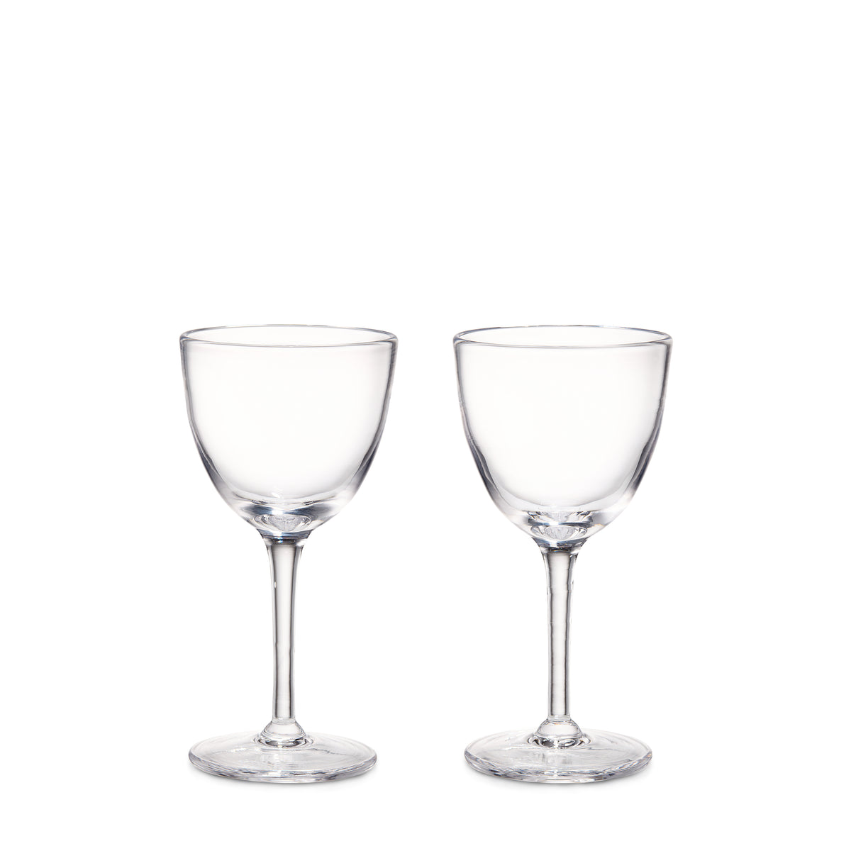 Two clear glass cocktail glasses with rounded bowls and thin stems on circular bases.